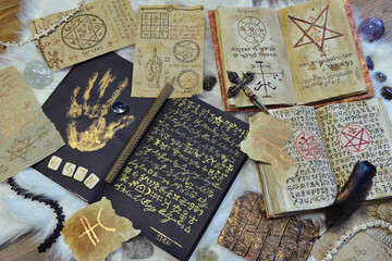 Still life with old manuscripts, parchments and papers with magic symbols, spells and pentagram on...