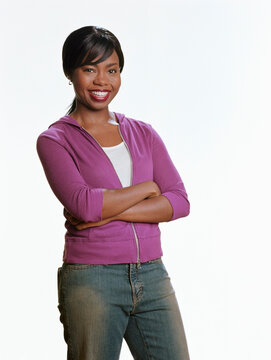 Young woman standing with her arms crossed