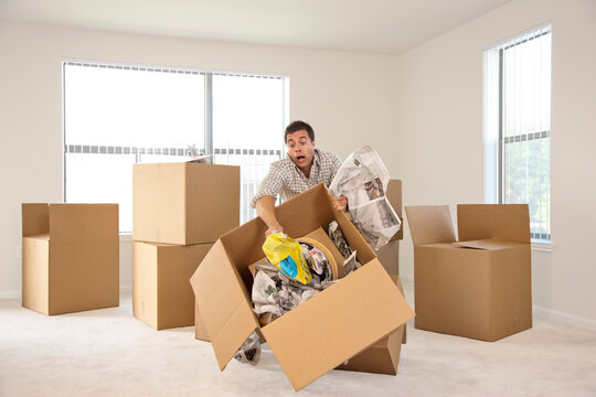Box falling while man is moving into new house