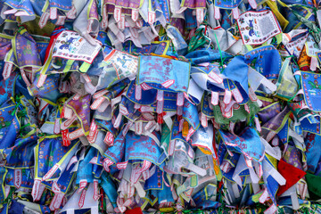 Fototapeta na wymiar Bright prayer flags with sacred texts in Buddhist temple in St. Petersburg, Russia. This beautiful religious building (The Datsan Gunzechoinei) is located on Primorsky Ave.