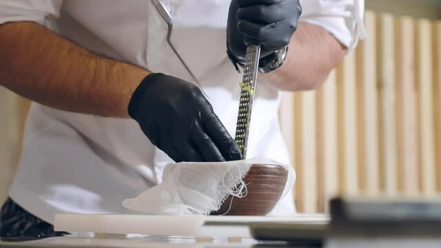 The chef processes the celery root into small pieces. Rub the celery root on a grater.