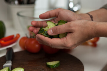 person cutting vegetables,female hands hold chopped vegetables for salad, kitchen cooking 