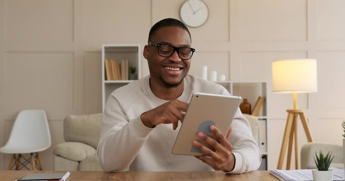 Happy man using digital tablet at office