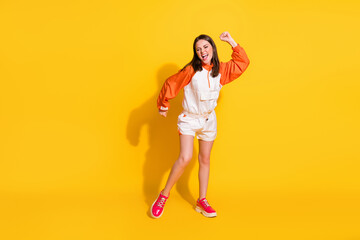 Photo portrait full body view of woman dancing isolated on vivid yellow colored background