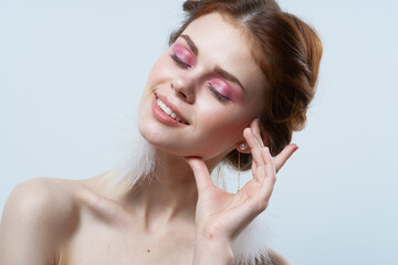 Fototapeta premium pretty woman bare shoulders fluffy earrings cropped view close-up luxury