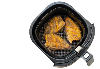 Deep fried fish in tray of hot air fryer or oil-free fryer, top view image, isolated on white background. The concept for modern and healthy cooking. The fried fish is Snakeskin gourami fish.
