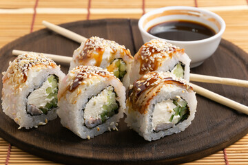 sushi on a round plate with chopsticks