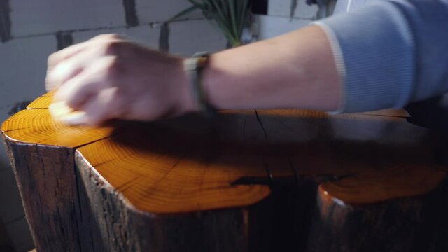 polishing a wooden stump with wood impregnation and shellac. cutting a wooden stump. woodworking concept. wood texture
