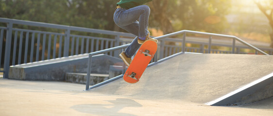Asian woman skateboarder skateboarding at skatepark