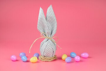 Happy easter. egg with bunny ears on a pink background. DIY eggs decorated with homemade.