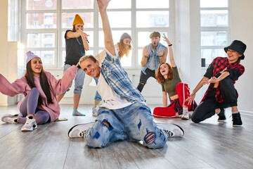 trendy teenagers dancing hip-hop in studio, learn dance moves together, wearing stylish outfit