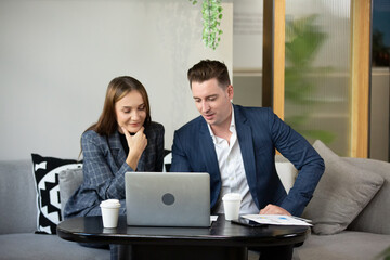 Business people talking in office using digital tablet and computer