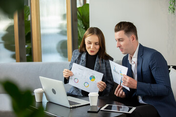 Business people talking in office using digital tablet and computer