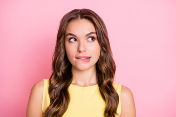 Portrait of young beautiful attractive happy positive good mood girl look copyspace bite lips isolated on pink color background