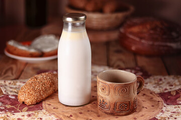 clay mug and bottle of milk, wholemeal croissant, still life