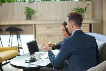 Business people talking in office using digital tablet and computer