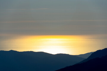 sunset in the mountains over the sea