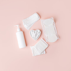 Tampons, feminine sanitary pads, liquid intimate soap on a pink background. Hygiene care during critical days. Menstrual cycle. Caring for women's health. Monthly protection, copy space