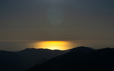 sunset in the mountains over the sea