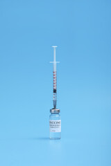 Medicine bottle with coronavirus vaccine covid-19. Medical glass vial and syringe for vaccination....