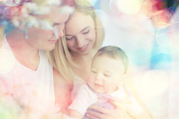 baby with parents in a cozy house / healthy young family mom dad and baby, happiness smile