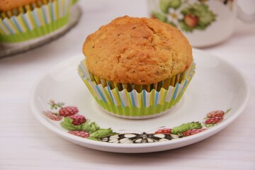 Homemade cupcakes with alamonds and chia seeds on white wooden background coffee cup
