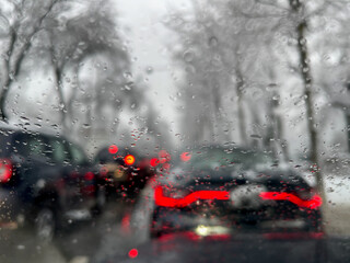 Detail view of some raindrops on a windshield in the morning traffic from Bucharest