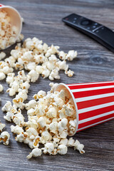 A vertical closeup of two paper cups with fresh popcorn