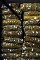 Traditional Oriental dolmades - stuffed grape leaves baked in ceramic form
