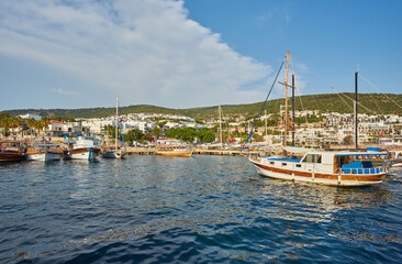 Fototapeta na wymiar View of the Gumusluk Bodrum Marina, sailing boats and yachts in Bodrum town, city of Turkey.