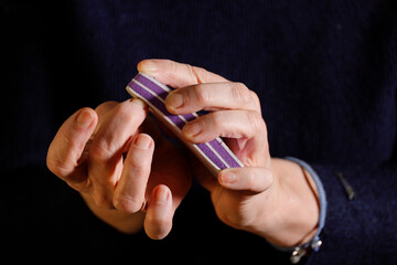 A woman files her fingernails with an emory board.