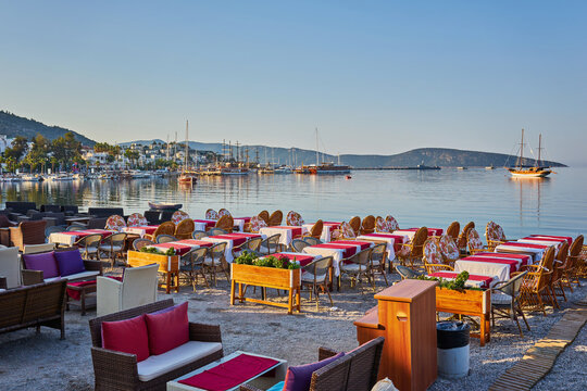 Cute chairs and table on the beach at seaside restaurant in Bodrum