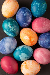 Easter eggs on black concrete, top view