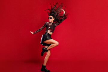 Full body profile side photo of charming lady dance fly hair raise hand isolated on red color...