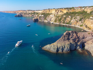 Obraz premium Cape Fiolent. Beautiful views of the Black Sea coast at Cape Fiolent in summer in clear weather. Aerial view to beautiful sea coast with turquoise water and rocks