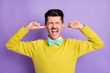 Portrait of brunet stressed guy close ears yell wear yellow sweater isolated on pastel lilac color background