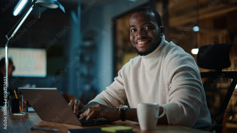 Poster handsome black african american man having an online conversation on a laptop computer in creative o