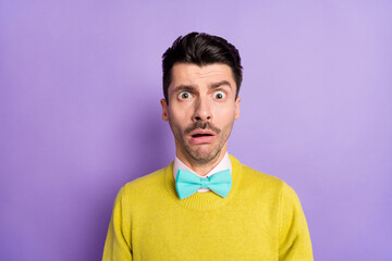 Portrait of brunet scared guy wear yellow sweater isolated on pastel lilac color background