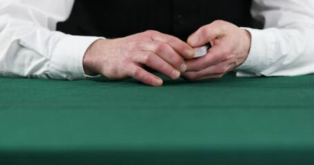 Professional casino croupier shuffling and dealing cards, gambling, close-up