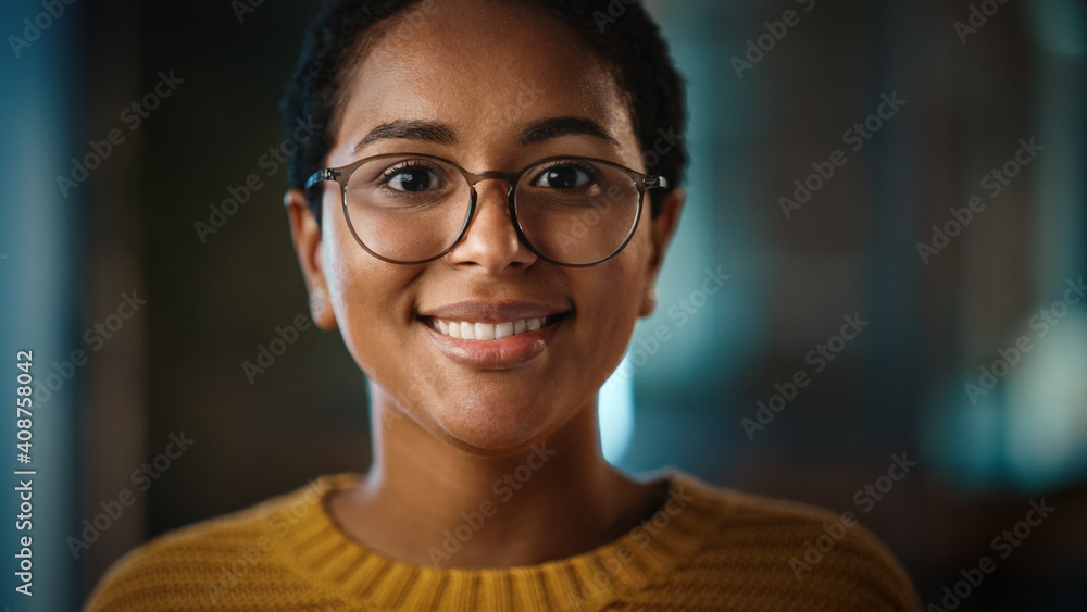 Poster close up portrait of a young non-binary latina with short dark hair and glasses posing for camera in