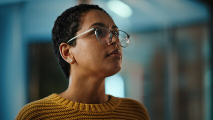 Close Up Portrait of a Young Latina with Short Dark Hair and Glasses Posing for Camera in Creative...