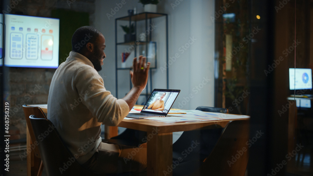 Aufkleber handsome black african american project manager is making a video call on laptop computer in a creat