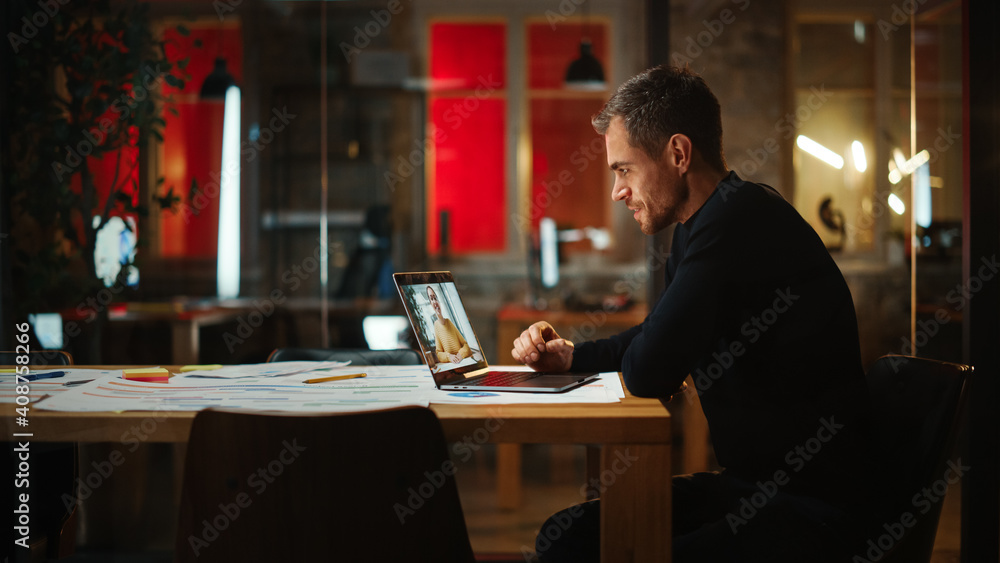Poster Handsome Caucasian Project Manager is Making a Video Call on Laptop Computer in a Creative Office Environment. Male Specialist Talking to a Multiethnic Latina Colleague Over a Live Camera.