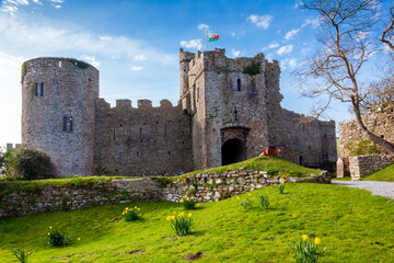 Manorbier Castle in Pembrokeshire south Wales UK which is an 11th century Norman fort ruin and a popular travel destination tourist attraction landmark, stock photo image - obrazy, fototapety, plakaty