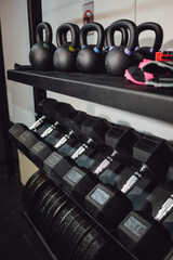 Kettlebells and dumbbells in the gym for sports. Iron for muscle training. Healthy lifestyle.