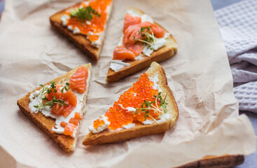 sandwiches of bread red caviar and fish