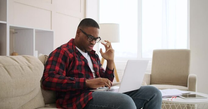 Crazy man celebrating online success using laptop at home