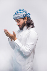 Religious muslim man praying on grey background