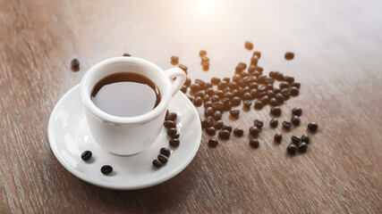 Coffee cup and saucer on a wooden table. Dark background.