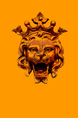 Bronze lion head with crown isolated on orange background illustration